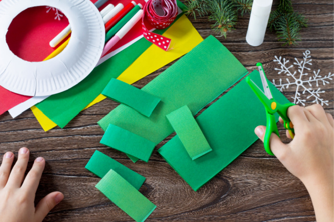 cutting strips of green paper